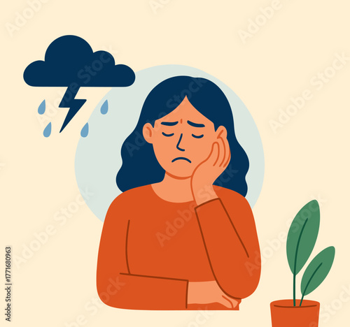 Woman feeling sad sitting in chair with hand on forehead