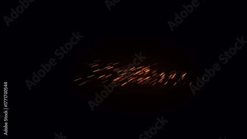 Dynamic motion of glowing fire sparks in the darkness.