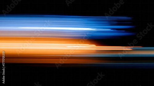 Horizontal light trails of contrasting blue and orange colors streak across a dark background