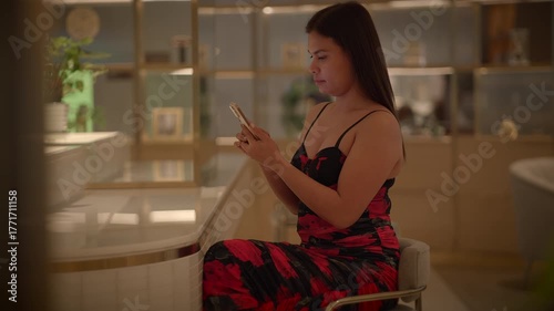 asian woman relaxing with phone, indoor scene of asian woman engaged with her phone comfortably