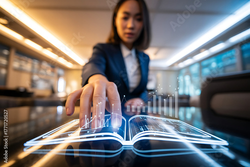 Businesswoman touching a futuristic glowing book with data visualization