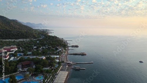 Scenic aerial drone view of mountain coastline with blue sea, sandy beaches and seaside resorts. Beautiful summer travel destination. Turkey