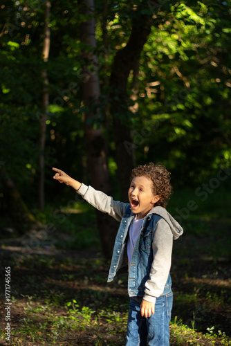 Curious Boy Exploring Nature in Park. 10 year old boy exploring something on tree. His focused expression captures wonder of childhood discovery and learning about the natural world. High quality