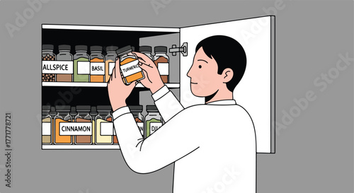 A person in a kitchen, holding a spice jar labeled "Turmeric" from a spice rack