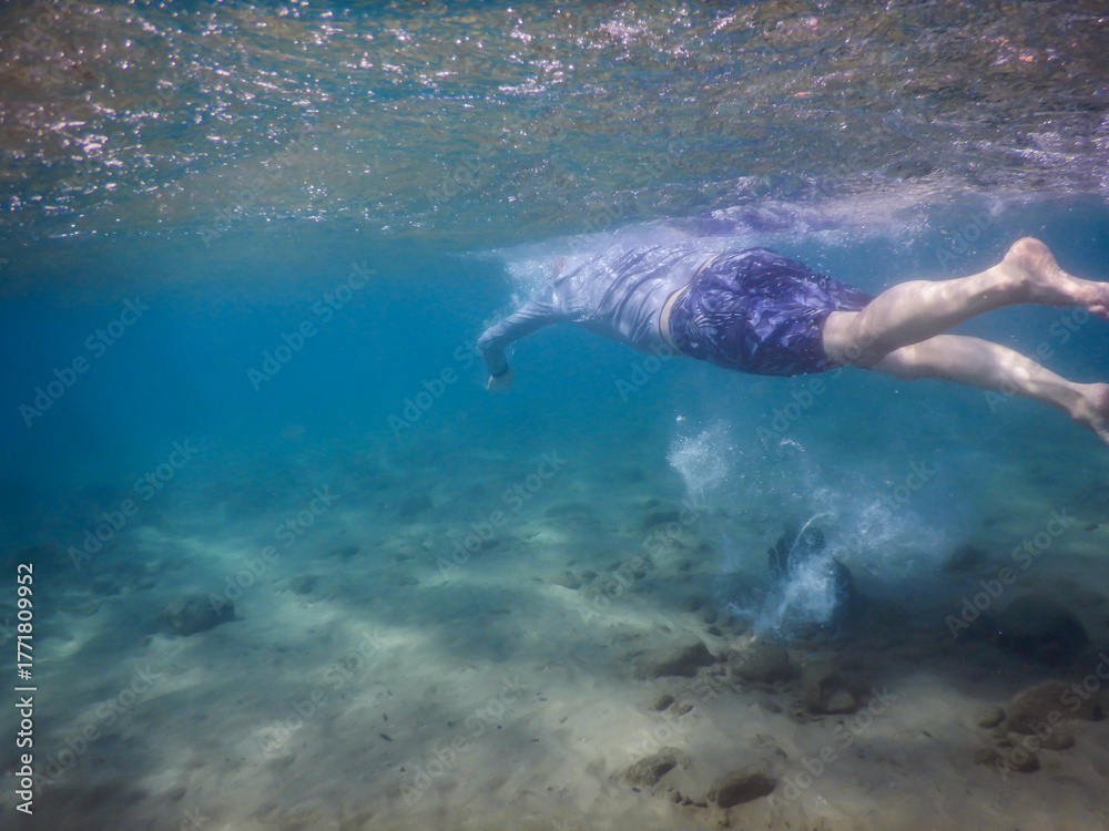 Fototapeta premium Underwater shot of man swimming