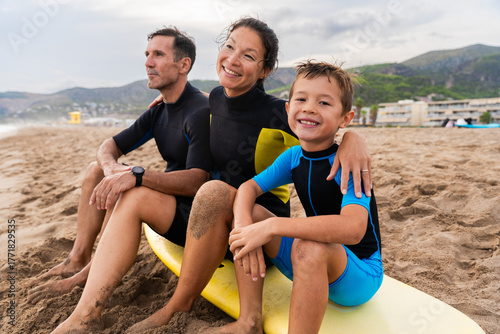 Photography Happy multiracial family having surfing lesson at the beach during summer vacati