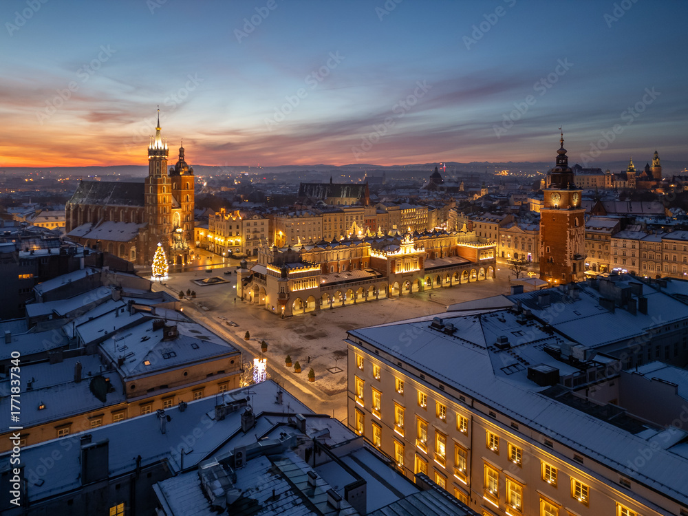 Fototapeta premium Aerial late night / dawn view of snow covered Main Square with St Mary's church and Cloth Hall with Christmas Tree in Krakow, Poland