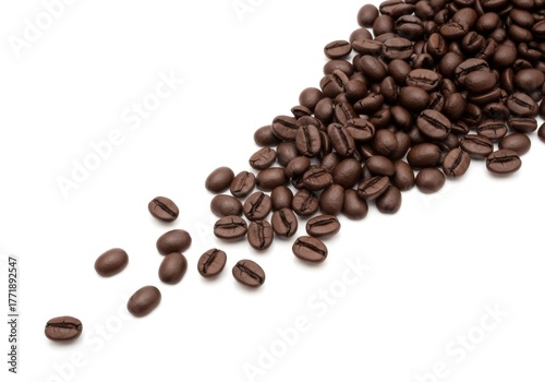 Aromatic roasted coffee beans spilling across a pristine white isolated background with copy space