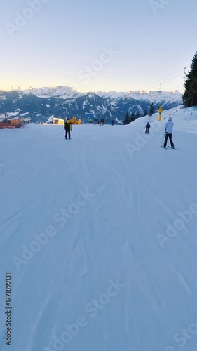 Vertical View of Skiers Skiing on Snowy Alpine Slope in Winter Alps Ski Resort