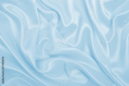 Smooth elegant blue silk or satin luxury cloth texture as abstract background. Luxurious background design