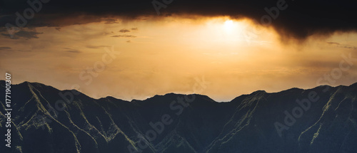 Dramatic Hawaiian Mountain Peak Beneath Dark Storm Clouds
