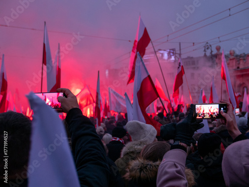 Photos crowd with polish flags and flares during the independence march in warsaw