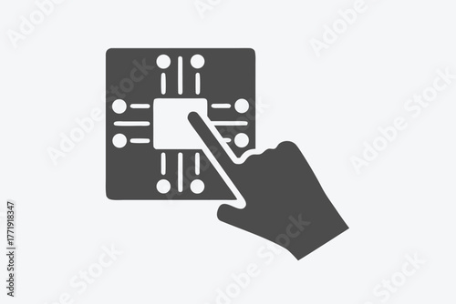 Human finger touches a square shaped circuit board in dark gray shade displaying technology