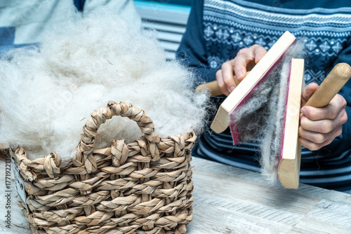 The skill of carding wool by hand, is crucial for producing quality yarn.
