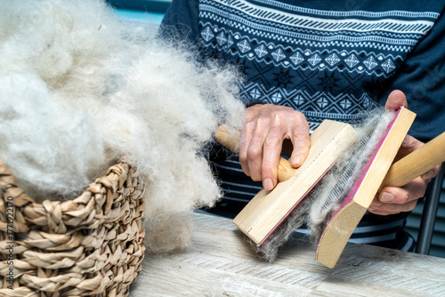 The skill of carding wool by hand, is crucial for producing quality yarn.