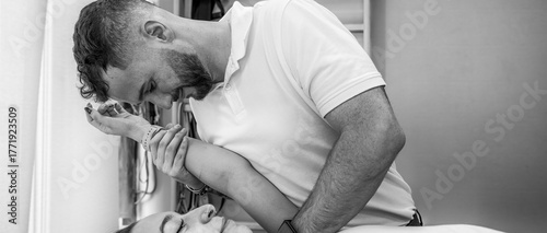 Physiotherapy treatment on a young woman’s shoulder in a professional clinic