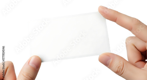 A person holding a blank white card between their fingers against a black background studio shot