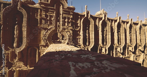 Tableau sur toile Intricate carvings and towering walls showcase the artistry of ancient builders in this monumental structure, bathed in sunlight and surrounded by a serene landscape