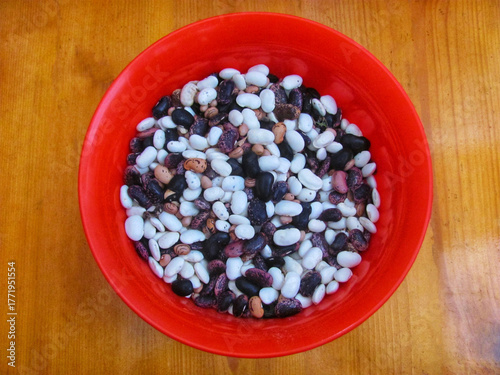 Assortment of dried beans in a red bowl