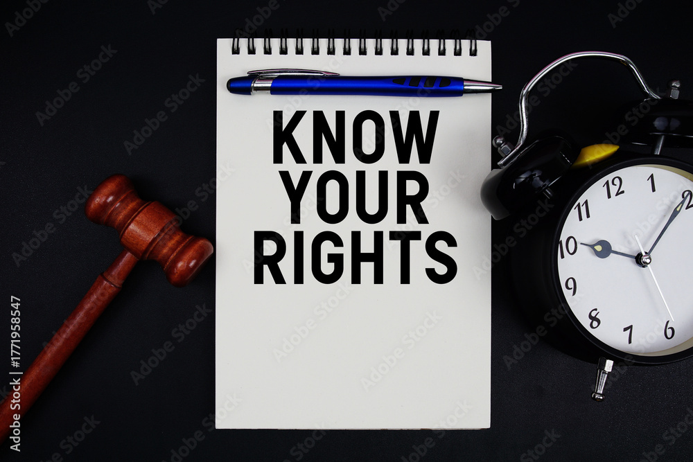 Fototapeta premium Know Your Rights text written on notepad with gavel and alarm clock on black background