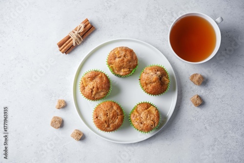 Cinnamon muffins with pear slices in a plate on a white background