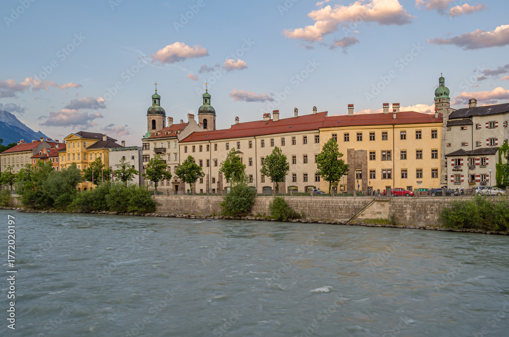 Fototapeta premium Buildings with colorful facades on the banks of the Inn River in Innsbruck, Austria