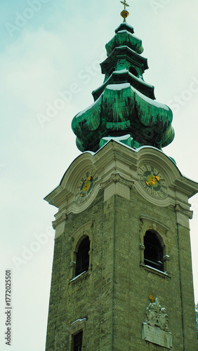 Traditional Austrian bell tower standing amid snowy alpine peaks