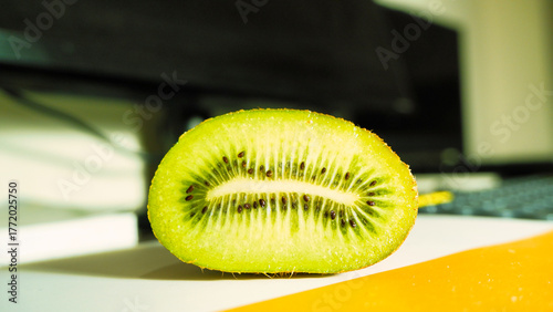 Fresh ripe kiwi fruit sliced in half, showcasing its vibrant green flesh