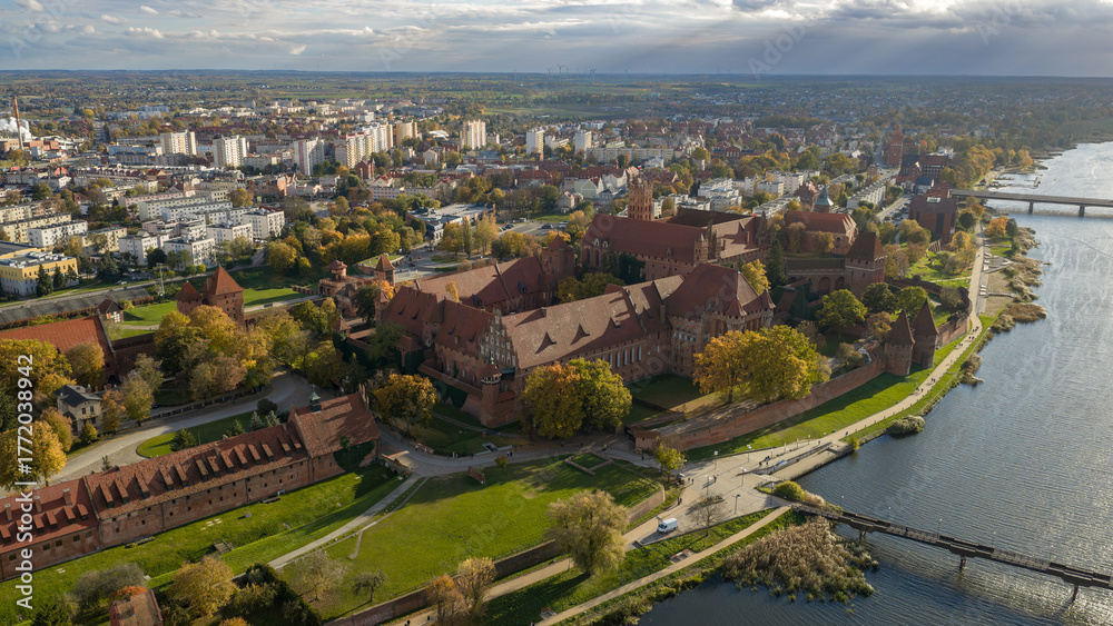 Fototapeta premium Aerial view of Malbork Castle and Nogat River in late afternoon