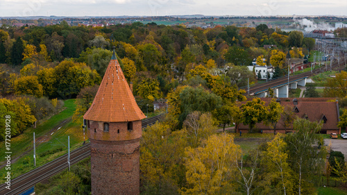 Aerial autumn view of red brick tower near Malbork railway lines