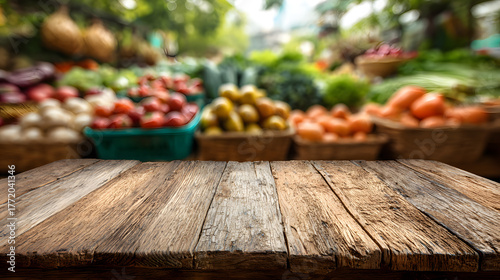 Fototapeta Naklejka Na Ścianę i Meble -  Empty wooden table with blurred background of fresh produce at a market