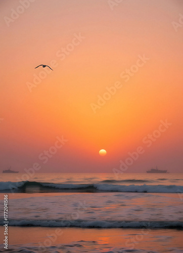 A sunset scene over the ocean, where the colors of the sky range from orange and pink to yellow.