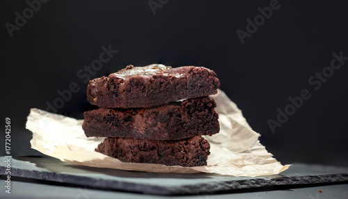 A stack of delicious chocolate brownies on a dark background