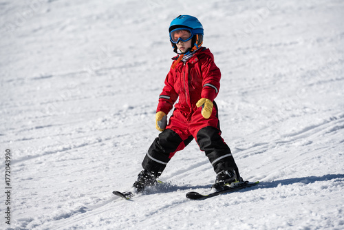 Wallpaper Mural Young child learning skiing on a sunny winter slope Torontodigital.ca