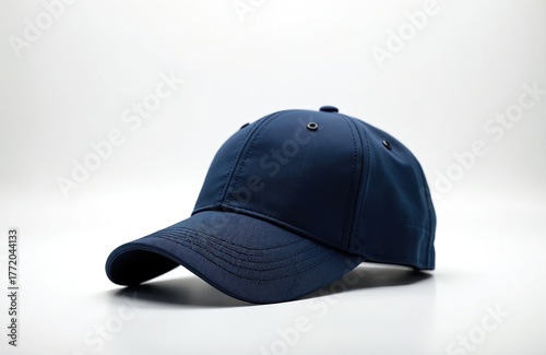 Wallpaper Mural Solid navy blue baseball cap sits isolated on clean white backdrop. This simple headwear piece offers classic casual style for everyday wear or sporting events. Useful for fashion, apparel concepts. Torontodigital.ca