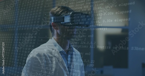 Analyzing scientist wearing white lab coat and VR headset in tech lab, with projected code lines