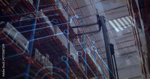 Displaying shelving racks holding boxes in warehouse, with forklift and circuit overlay, copy space