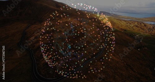 Hovering data globe floating above hillside and distant water, with winding road and neon outlines