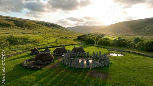 Celtic Stone Circle Village Amid Green Hills with Sunlight Breaking Through Clouds