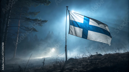 Finnish flag waving in the wind in a misty forest at night