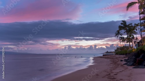 Timelapse of Tropical beach at sunset with palm trees and colorful clouds.