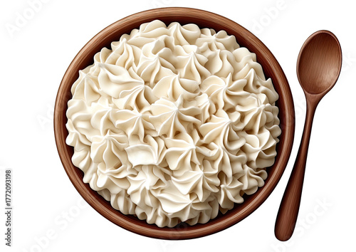 Creamy swirls fill bowl; wooden spoon rests alongside