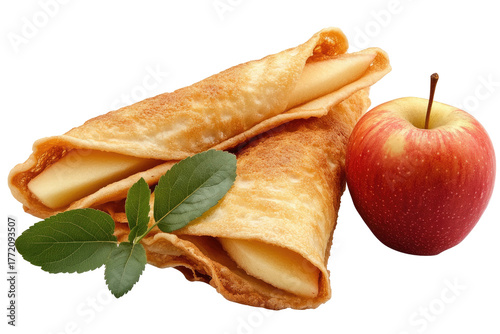 Rolled pancakes, apple, & basil leaves against black bg