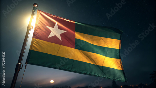 Togo flag waving against the night sky with a bright moon