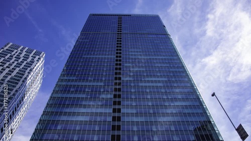 A timelapse of cloud reflecting the urban city building in Tokyo wide shot tilt