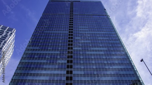 A timelapse of cloud reflecting the urban city building in Tokyo wide shot zoom