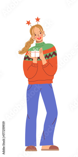 Young woman wearing cozy knitted winter sweater with pattern and headband with stars holds holiday gift in box with tied bow. Cute vector Christmas illustration.