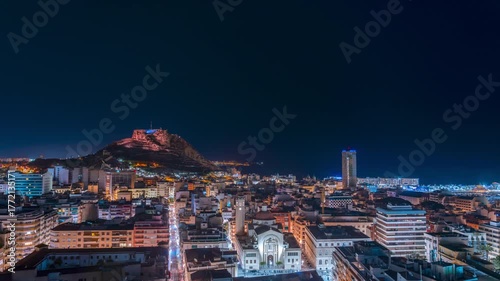 Timelapse of Cityscape at night with illuminated buildings and castle.