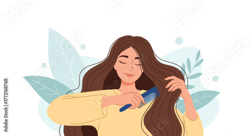 Relaxed young woman gently combs her long brown hair with a blue comb, eyes closed in a moment of serene self-care and beauty ritual.