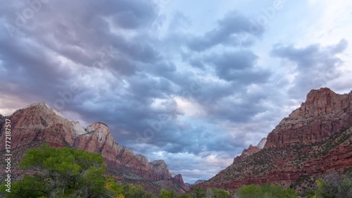 Timelapse of Dramatic clouds over Zion National Park sandstone cliffs.